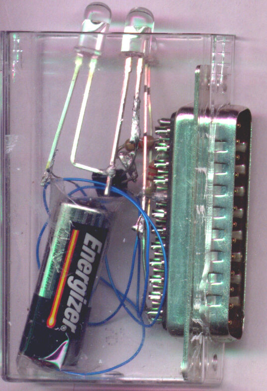 A clear casing with two lights, a battery, and a circuit